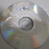 A close-up of a cd
AI-generated content may be incorrect.