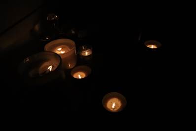 A group of candles in the dark
AI-generated content may be incorrect.